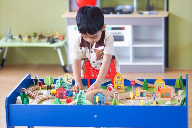 Boy playing at a colorful play table in a bright playroom with white shelves