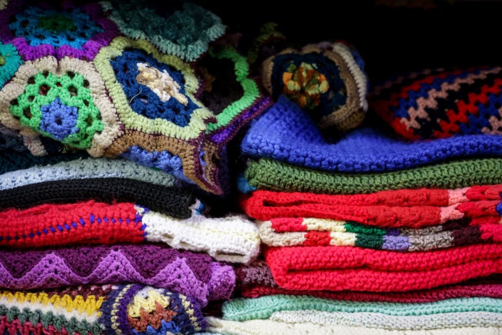 Stack of colorful handmade crocheted blankets
