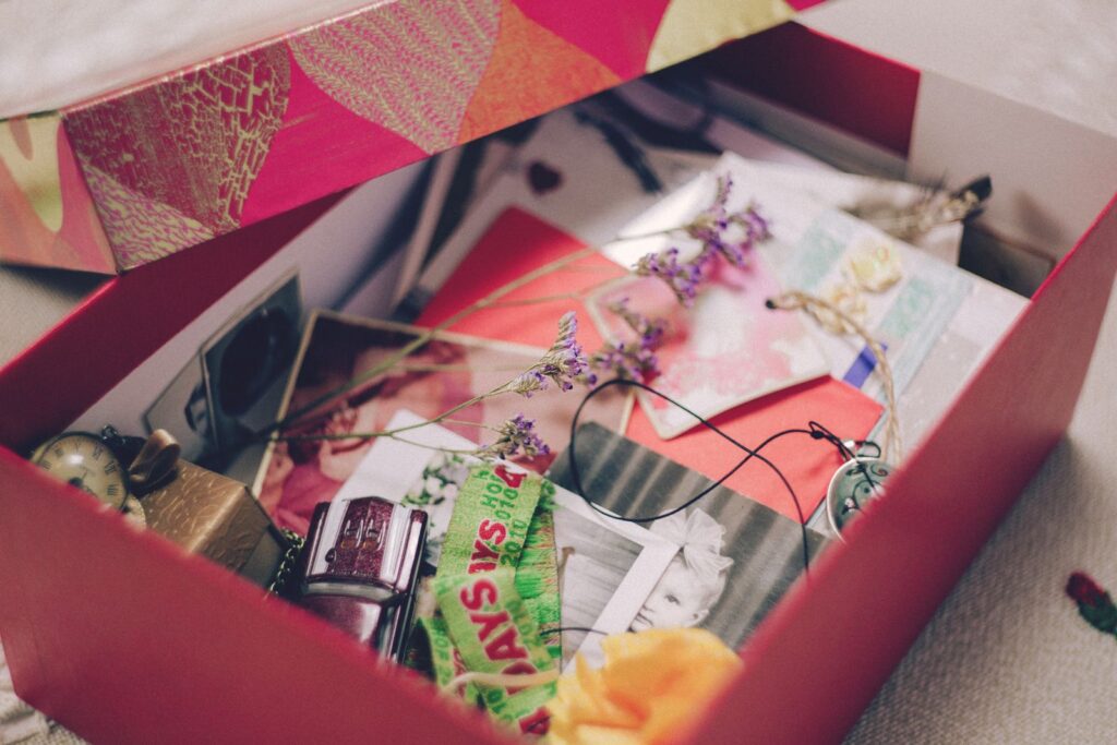 Red keepsake box filled with photos, cards and mementos