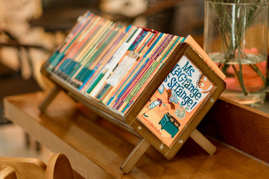 Children's picture books displayed face-out on a wooden stand