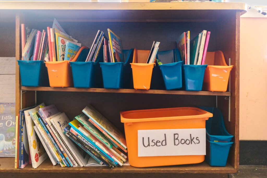 Children's bookshelf with colorful bins of picture books