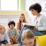 Children listening to a story on a bright yellow beanbag