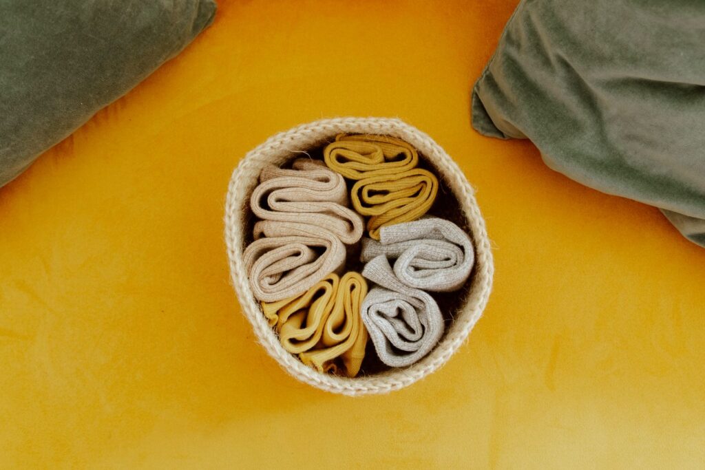 Woven storage basket on a bright orange background